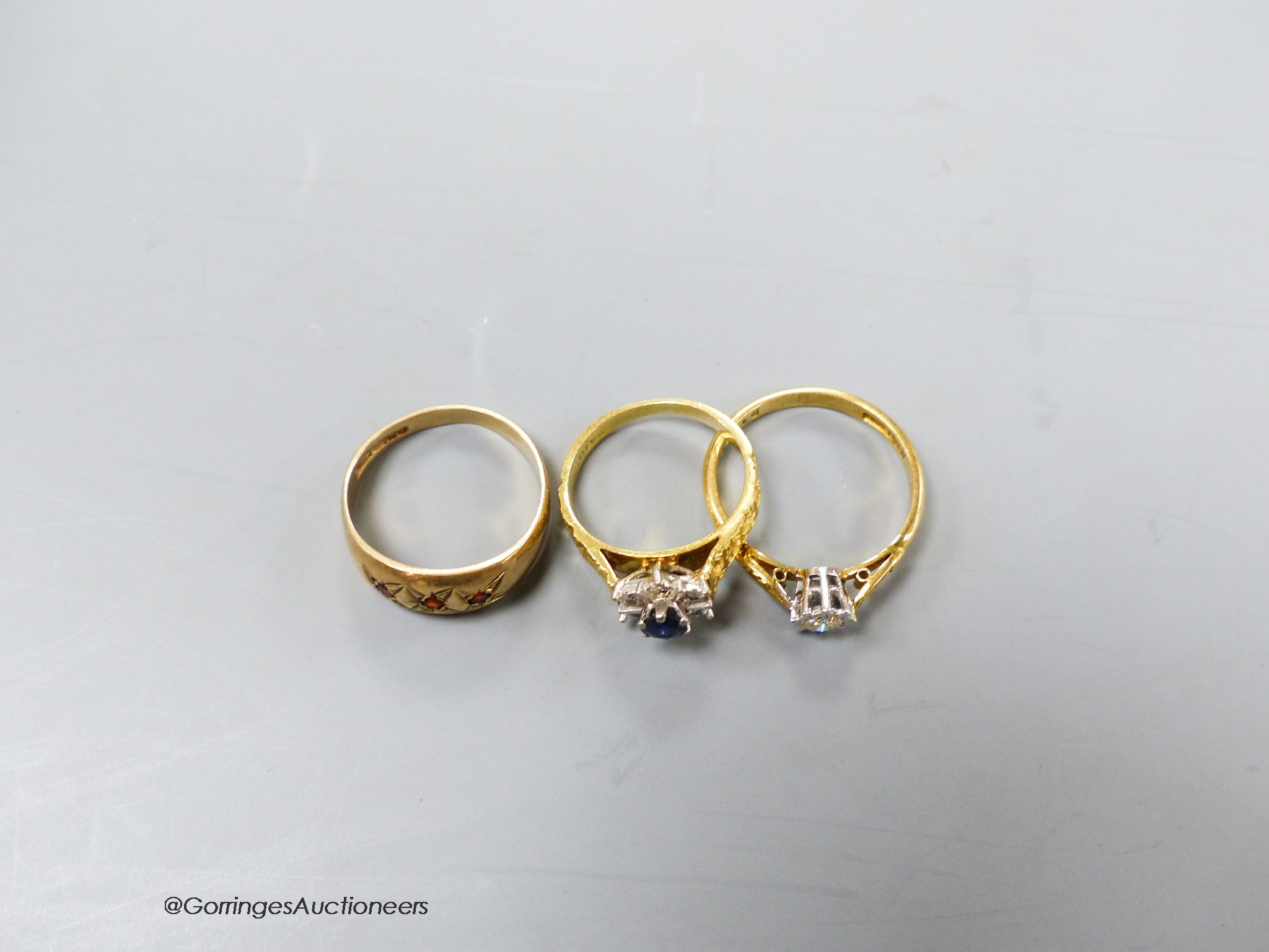 Two 18ct and gem set dress rings, gross 6.4 grams and a 9ct and gem set ring, gross 2.1 grams.